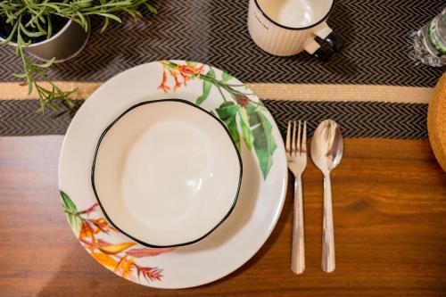 a plate and a fork and knife on a table at Skudai Tun Aminah Cozy Home - Sutera Mall 6 mins in Skudai