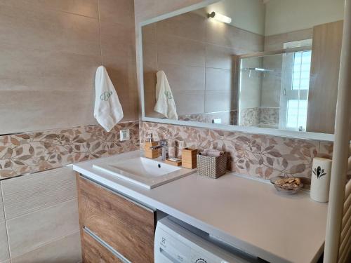 a bathroom with a sink and a mirror at Elia boutique apartment in Thiva
