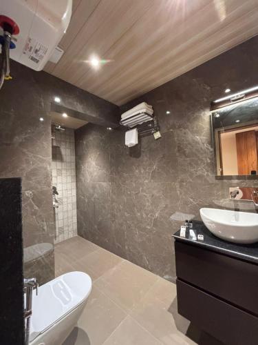 a bathroom with a sink and a toilet at Hotel Rajiv Palace in Sāhibganj