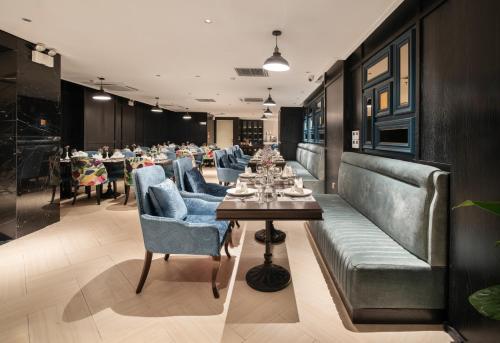 a dining room with a long table and chairs at Luxe Paradise Premium Hotel and Spa in Hanoi