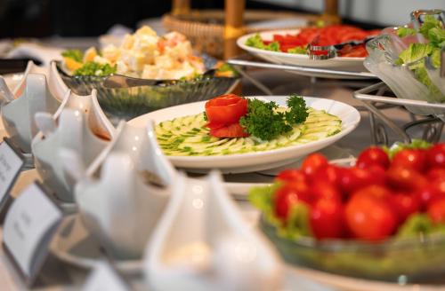 a buffet with plates of food on a table at Luxe Paradise Premium Hotel and Spa in Hanoi