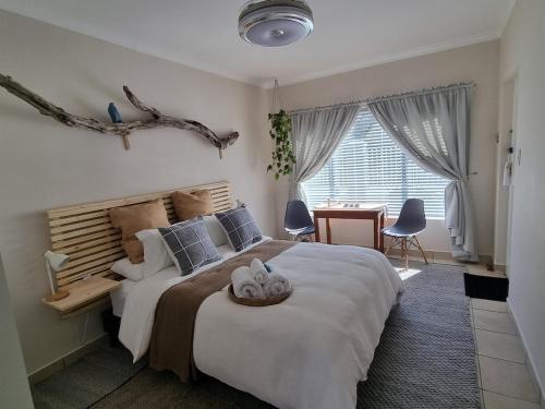 a bedroom with a large bed with a wooden headboard at Featherbed in Hermanus