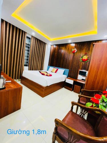a hotel room with a bed and a desk at SAPHIA Hotel Hue in Hue