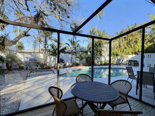 a patio with a table and chairs and a swimming pool at Crescent Beach 1011 #1 in Sarasota