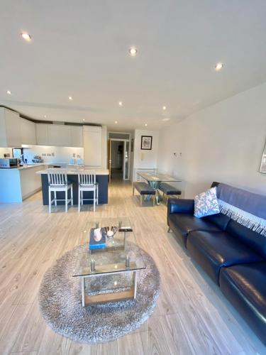 a living room with a couch and a table at Coastal Gem 10 Mins from Dublin Airport in Donabate