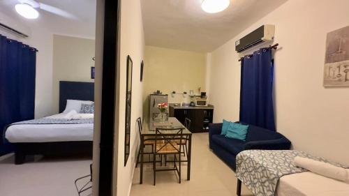 a room with a bed and a table with a chair at Hotel Tau Art Residence in Santo Domingo