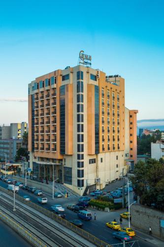a large building with a sign on the top of it at Capital Hotel and Spa in Addis Ababa