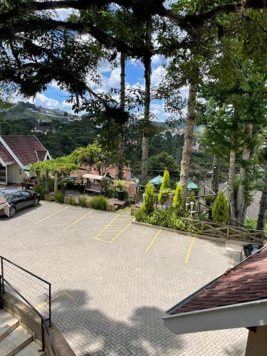 a parking lot with a car parked in it at Pousada Cantinho da Serra in Campos do Jordão