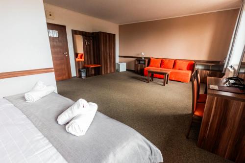 a hotel room with a bed and a desk at Hotel Avalanche in Štôla