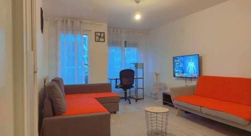 a living room with two couches and a flat screen tv at Ducastel F2 Appartment in Juvisy-sur-Orge