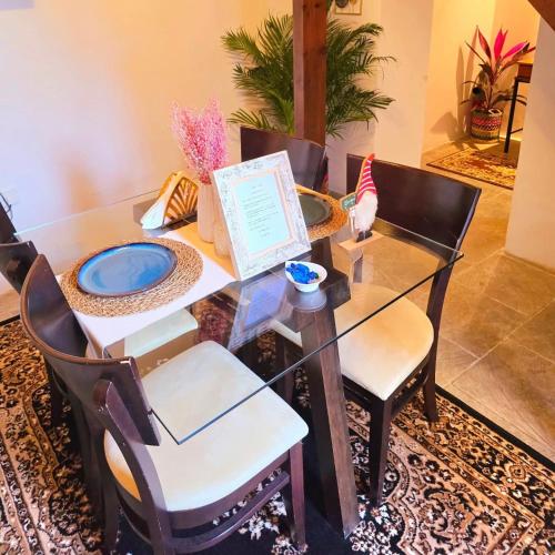 a dining room with a glass table and chairs at Kozakos Luxury House in Pano Lefkara