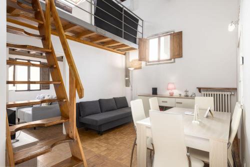 a living room with a staircase leading up to a loft at UNYCA - Casa San Gallo in Florence