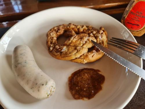a plate of food with a pretzel and a snack at Tablas Seaview Homestay in Ferrol