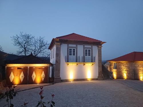 a house with a garage with lights on it at Exclusive Pena Rio in Ribeira de Pena