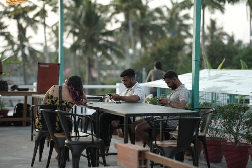 a group of people sitting at a table at Cliff and Coral Varkala, North Cliff in Varkala