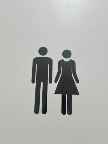 a sign for a man and a woman at Serene Homestay in Tawau