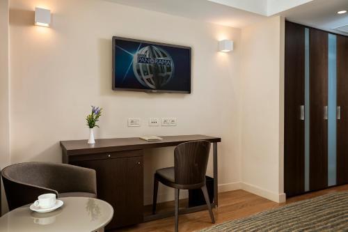 a room with a desk and two chairs and a table at Samaria Hotel in Chania Town