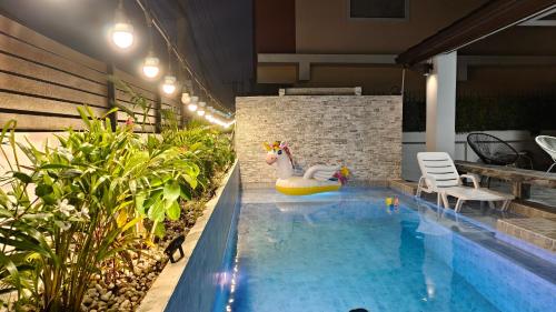 a pool with a unicorn in the middle of a building at DG Pattaya Pool Villa in Pattaya South