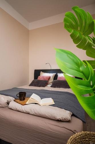 a bedroom with a bed with an open book on it at Modern & Bright Central Helsinki in Helsinki