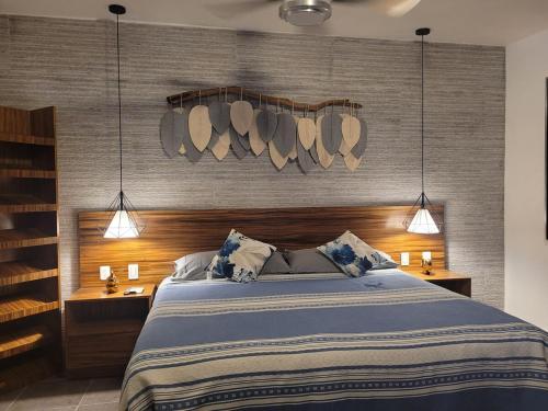 a bedroom with a large bed and two night stands at Casa Luz very nice in Nuevo Nayarit in Nuevo Vallarta 
