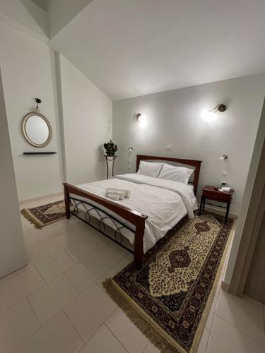 a bedroom with a large bed and a mirror at Jimilio 1 in Spata