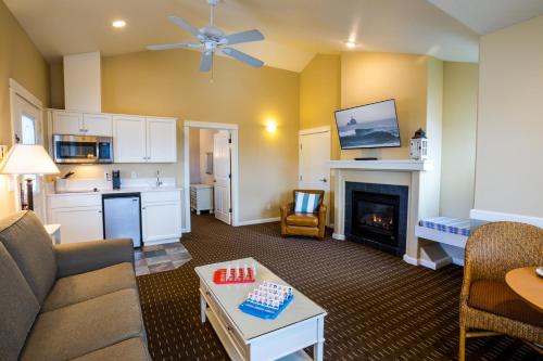 a living room with a couch and a fireplace at Lighthouse Inn in Cannon Beach