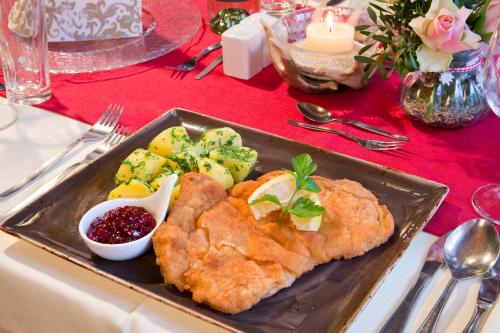 a plate of food with fish and vegetables on a table at Alpengasthof Gern Alm in Pertisau