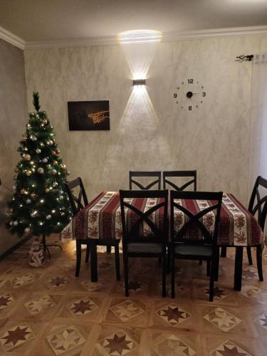 a dining room with a christmas tree and a table and chairs at Madoyans Rest House in Antarut