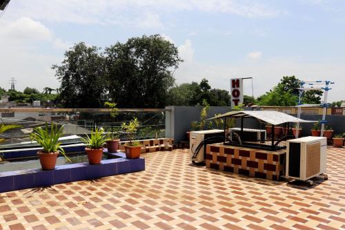 un patio en la azotea con plantas en el techo en Hotel Adarsh Palace, en Maheshwar