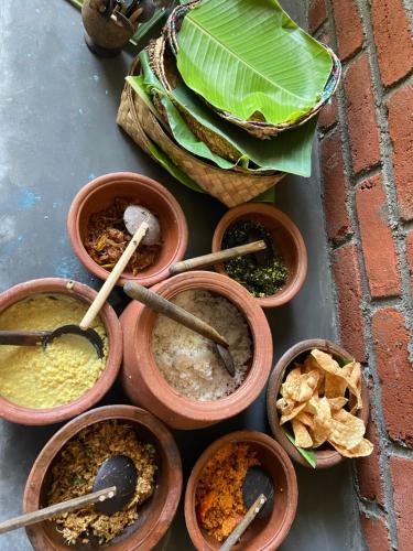 a group of pots filled with different types of food at Moonshade Handapanagala in Monaragala
