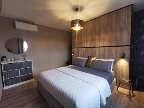 a bedroom with a large bed with a wooden headboard at A Flor da Rosa in Vila Nova de Foz Coa