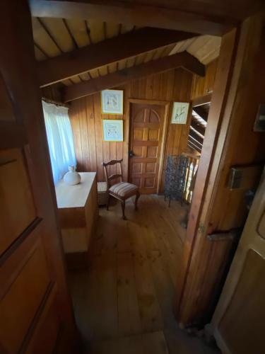 a view of a room with a chair and a table at Casa amplia con piscina y quincho in Concepción