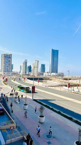 a group of people walking around in a city at Al Reem 1BR City View Pool Gym Family Biz Friendly Abu Dhabi in Mushayrib