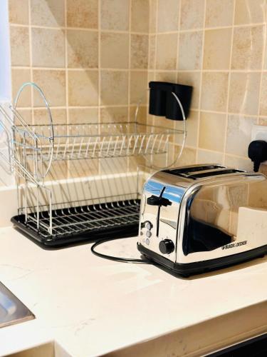 a toaster sitting on top of a kitchen counter at Al Reem 1BR City View Pool Gym Family Biz Friendly Abu Dhabi in Mushayrib