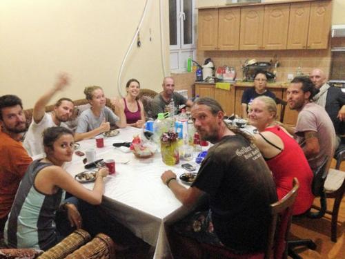 a group of people sitting around a table at Green House Hostel in Dushanbe