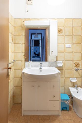 a bathroom with a sink and a mirror at FARE BnB - Room Pappagnocca in Reggio Emilia