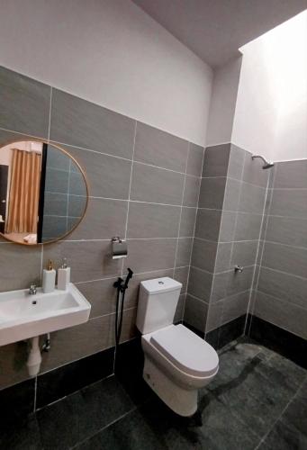 a bathroom with a toilet and a sink at Golden Paradise in Kuantan
