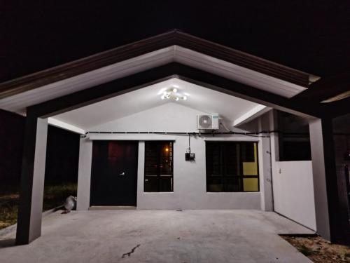 a garage with a white garage door at night at Golden Paradise in Kuantan