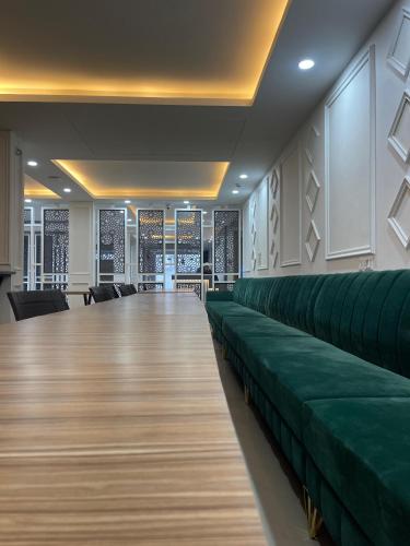 a waiting room with green seats in a building at Hotel Zoon Dabb Srinagar airport kashmir in Srinagar