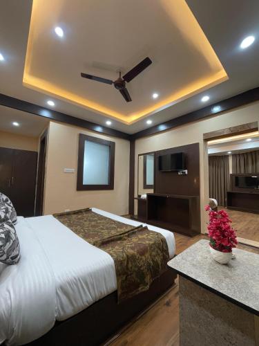 a bedroom with a large bed and a flat screen tv at Hotel Zoon Dabb Srinagar airport kashmir in Srinagar