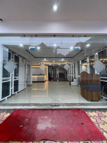 a large hall with a red carpet in a building at Hotel Zoon Dabb Srinagar airport kashmir in Srinagar
