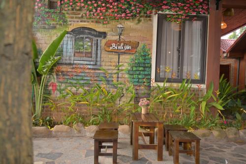 a building with a table and chairs in front of it at TamCoc Moon An Bungalow & Cafe in Ninh Binh