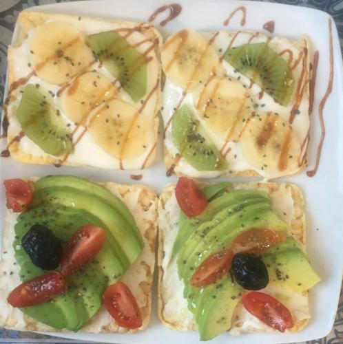a white plate with four sandwiches with fruit on it at Riad Al Manara in Essaouira