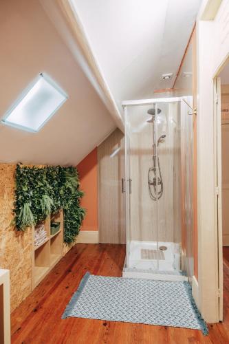 a bathroom with a shower in the attic at Vintage Beach House in Matosinhos