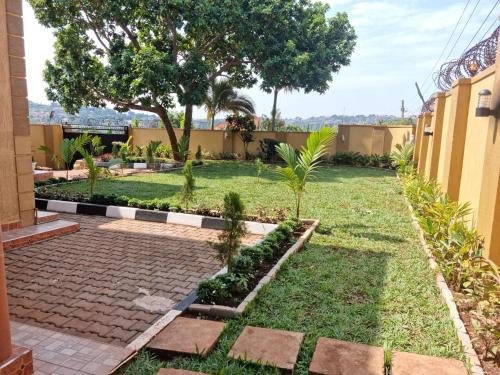 a garden with a brick walkway and plants at Akright Villa in Buzzi