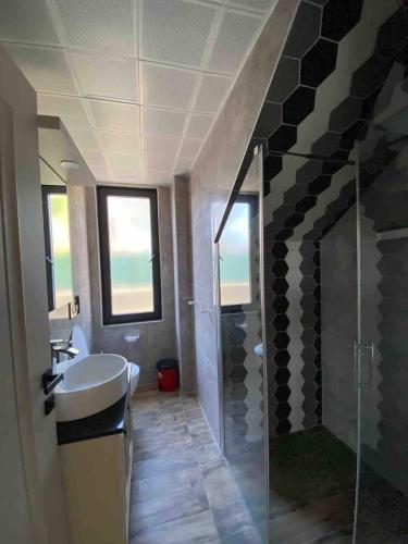 a bathroom with a sink and a glass shower at Detached and luxury villa in kadriye in Belek