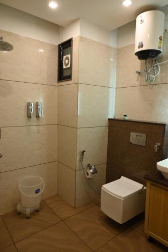 a bathroom with a shower with a toilet and a sink at Hotel Vaidik Ganga in Rishīkesh