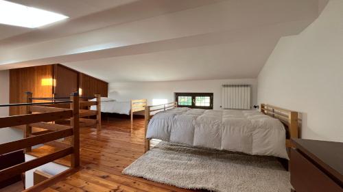 a bedroom with a large bed and a staircase at La tana dei Ricci in Fiano Romano