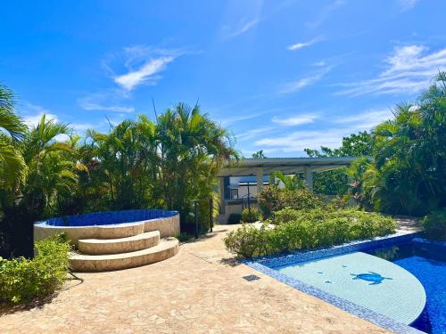 a house with a swimming pool and palm trees at Villas with breathtaking seaview in Marbella