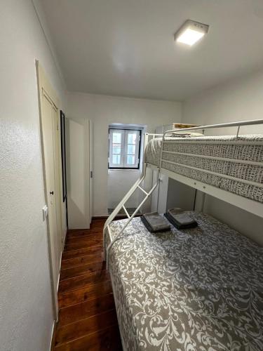 a bedroom with two bunk beds and a window at Cantinho das Portas do Sol II in Lisbon